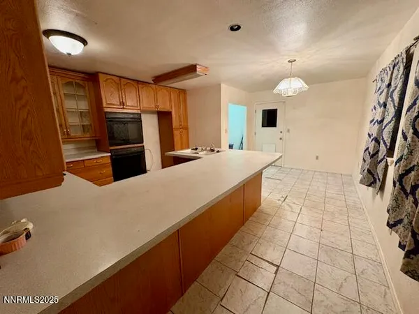 a large kitchen with a large counter top appliances and cabinets