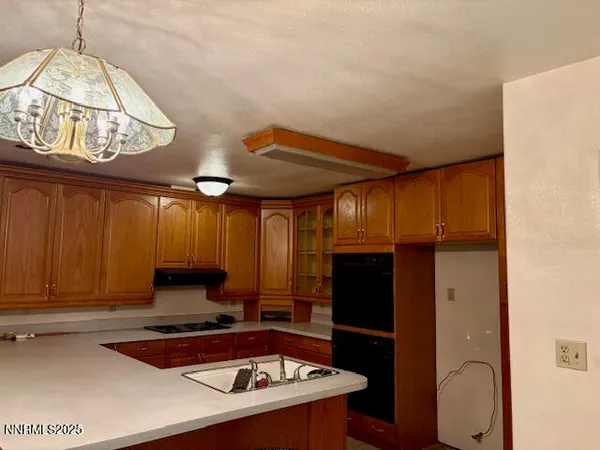 a kitchen with a sink a stove and a refrigerator