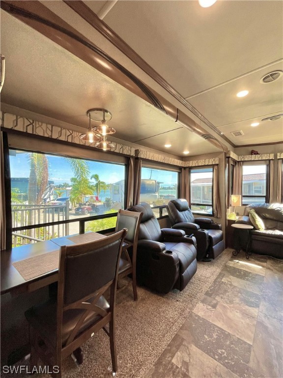 6800 Golf Course Boulevard, Unit E29 Punta Gorda, FL 33982 - Photo 17 of 23 a living room with furniture a flat screen tv and a floor to ceiling window