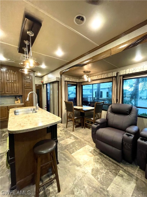 6800 Golf Course Boulevard, Unit E29 Punta Gorda, FL 33982 - Photo 8 of 23 a living room with furniture a chandelier and a projector