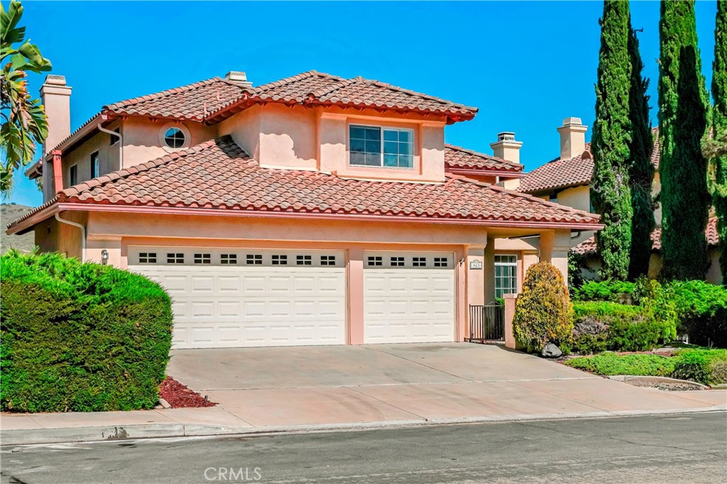 663 Corte Raquel San Marcos, CA 92069 - Photo 1 of 1 a front view of a house with a garden