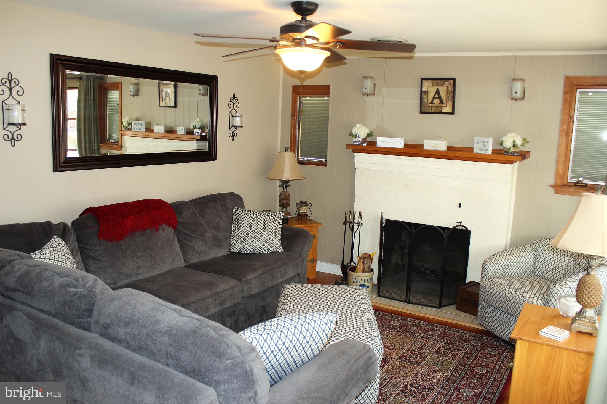 222 Dale Road Pasadena, MD 21122 - Photo 3 of 28 Living room w/wood burning FP and wood floors.