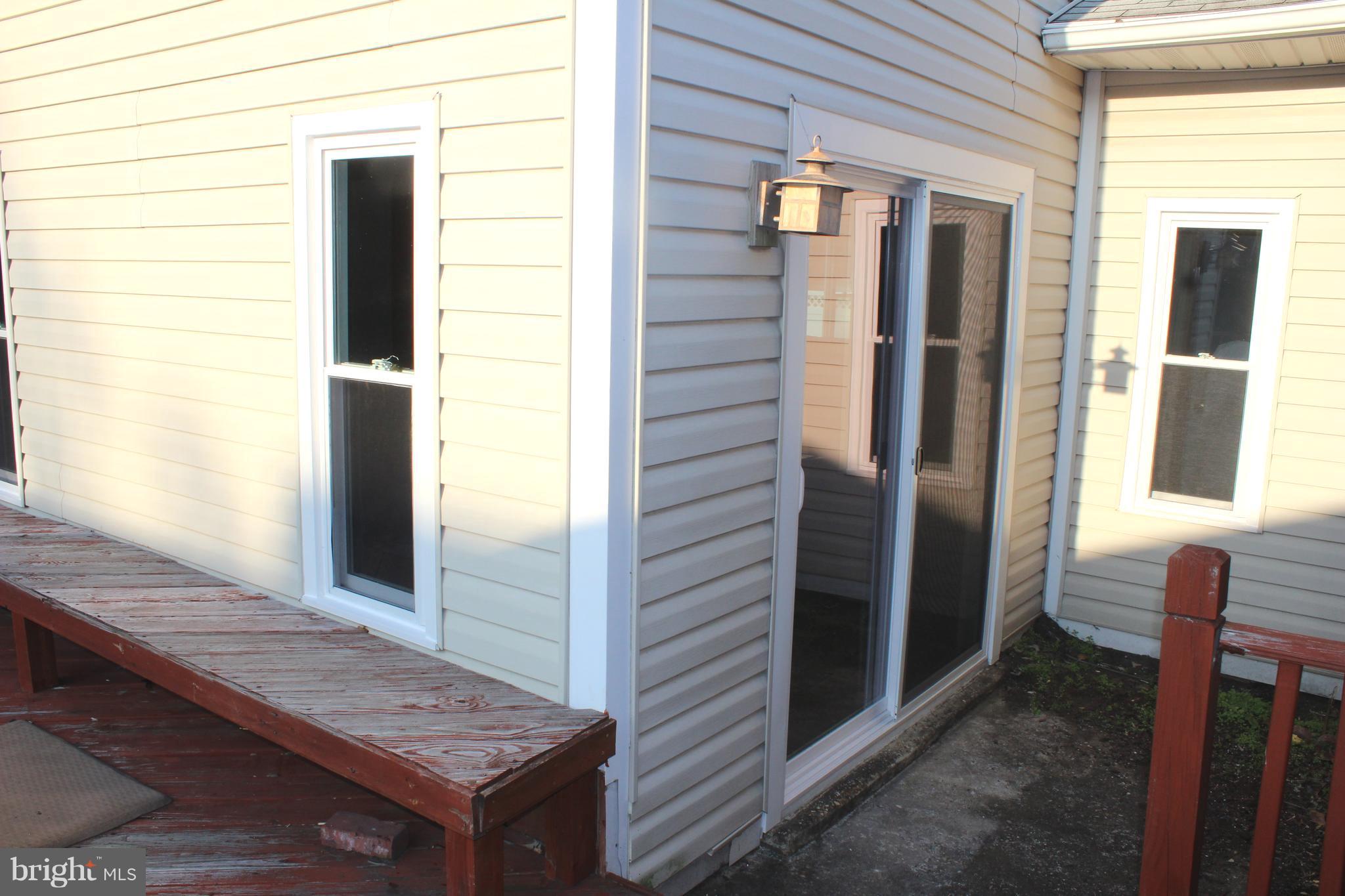 222 Dale Road Pasadena, MD 21122 - Photo 23 of 28 New windows and slider leading to deck.