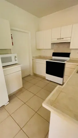 a kitchen with a sink cabinets and appliances