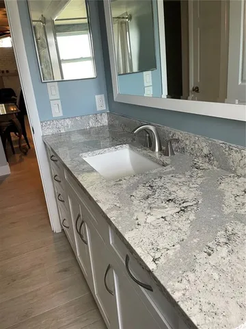 a white toilet sitting next to a bath tub