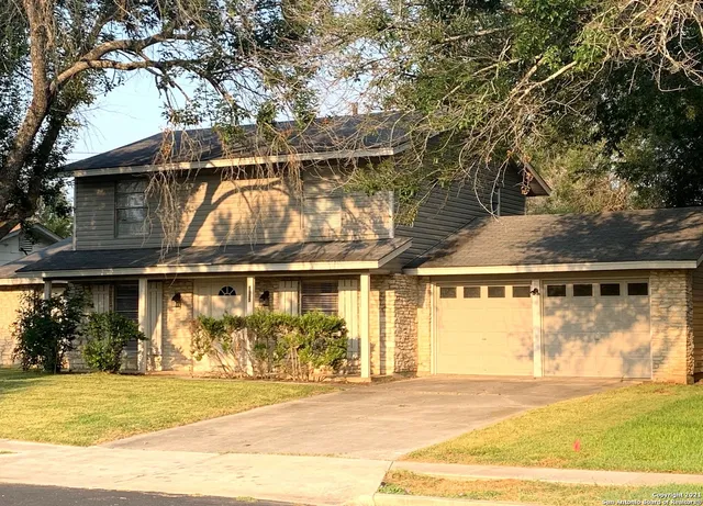 a view of a white house with a outdoor space
