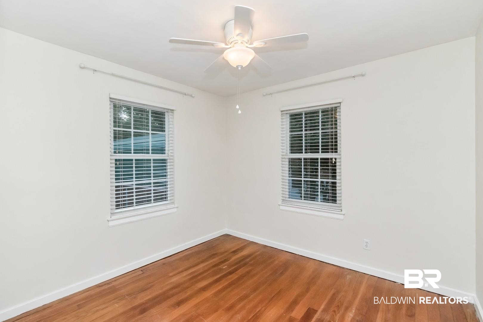 33 Lancaster Road Mobile, AL 36608 - Photo 22 of 40 Spare room with baseboards, wood finished floors, and a ceiling fan