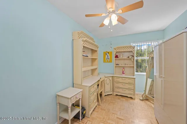 a view of kitchen with furniture and a fan