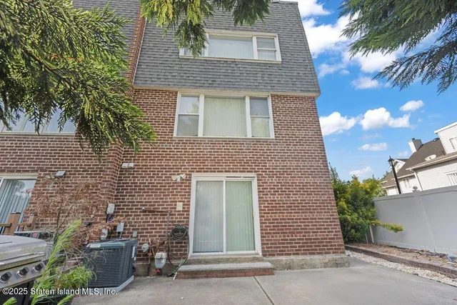 front view of a brick house with a street