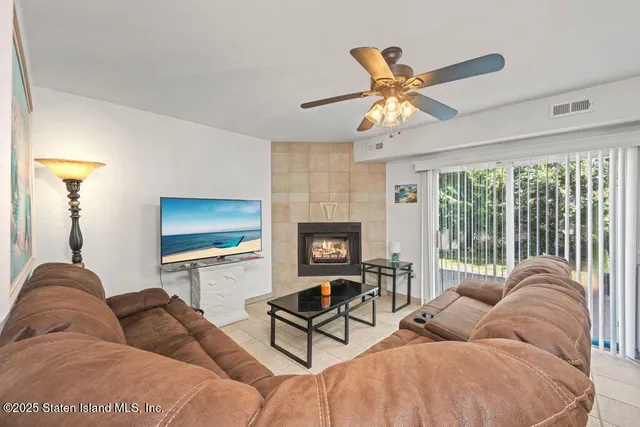 a living room with furniture a window and a flat screen tv