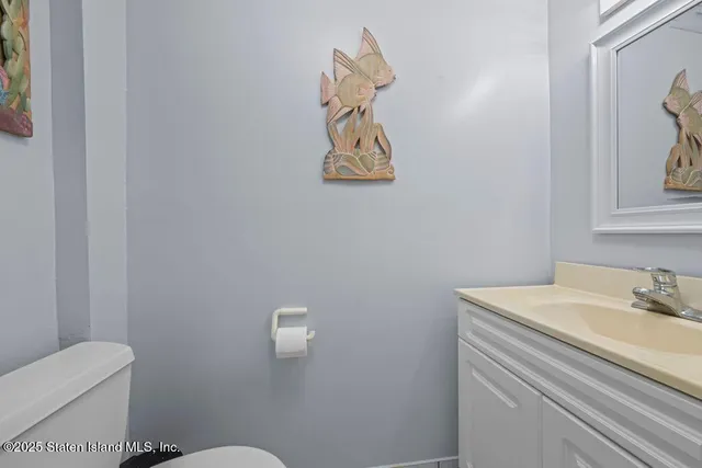 a bathroom with a sink mirror and toilet