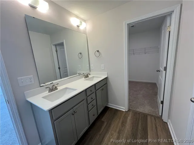 a bathroom with a double vanity sink and mirror