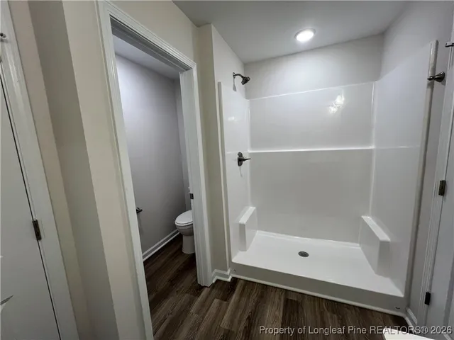 a bathroom with a glass door shower and a sink