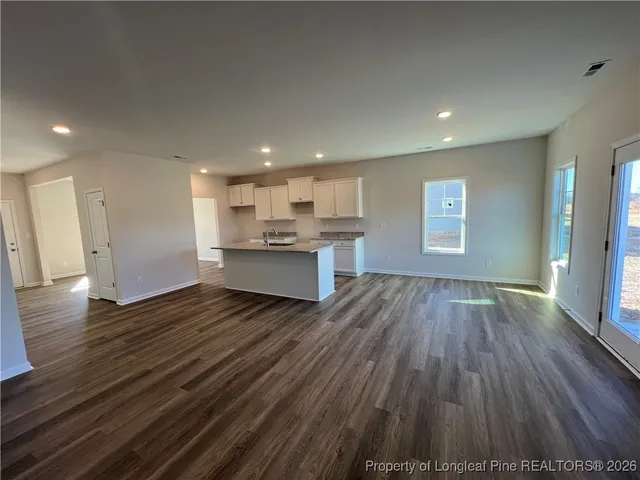 a view of a kitchen with wooden floor and electronic appliances