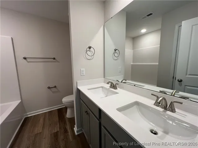 a bathroom with a sink toilet and mirror