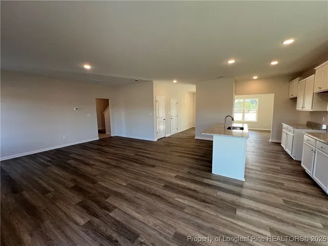 a view of kitchen and hall with wooden floor