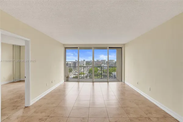 a view of an empty room with glass door