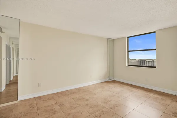 a view of an empty room with a window