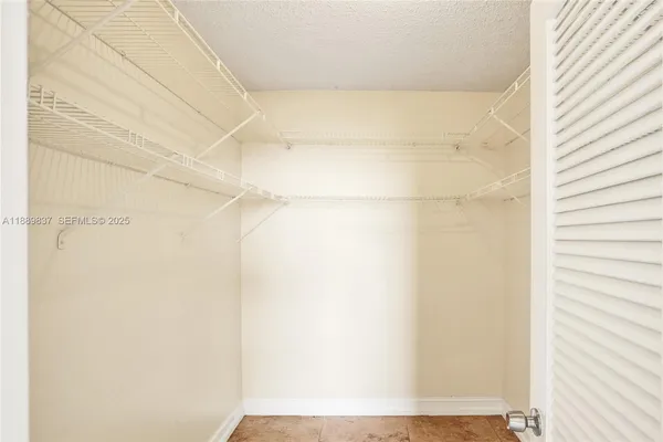 a view of a hallway with a refrigerator