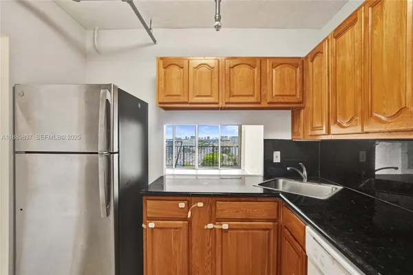 a kitchen with stainless steel appliances a stove a sink and a refrigerator
