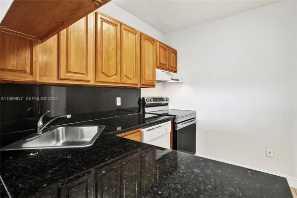 a view of a kitchen with a sink and cabinets