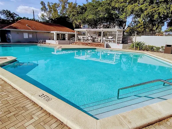 a view of a swimming pool with a yard
