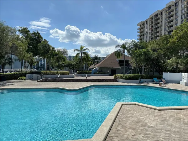 a swimming pool with outdoor seating and yard