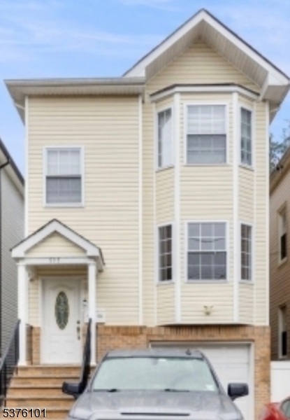 595 Monroe Avenue, Unit 2 Elizabeth, NJ 07201 - Photo 1 of 17 a front view of a house with a yard