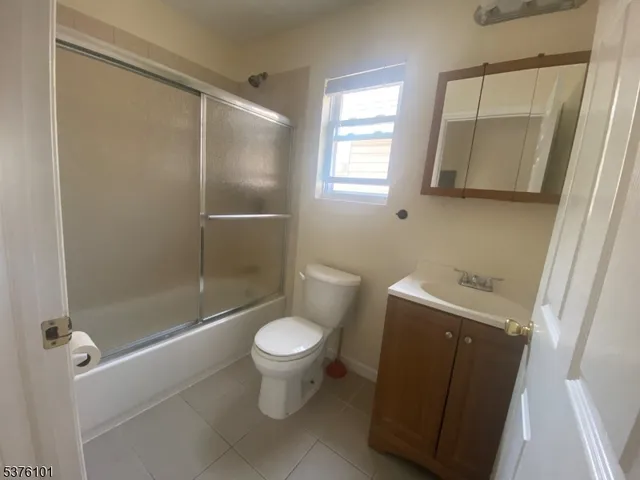 a bathroom with a shower a toilet and sink