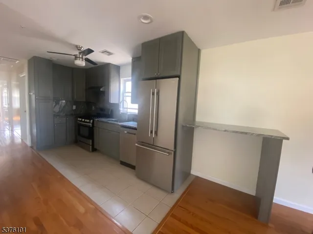 a kitchen with a refrigerator and a sink