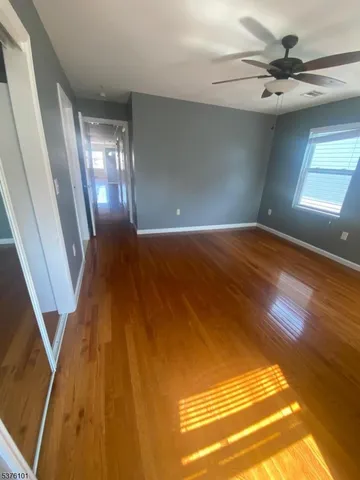 a view of an empty room and wooden floor