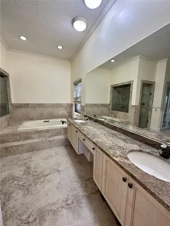 a large kitchen with granite countertop a sink and a stove top oven