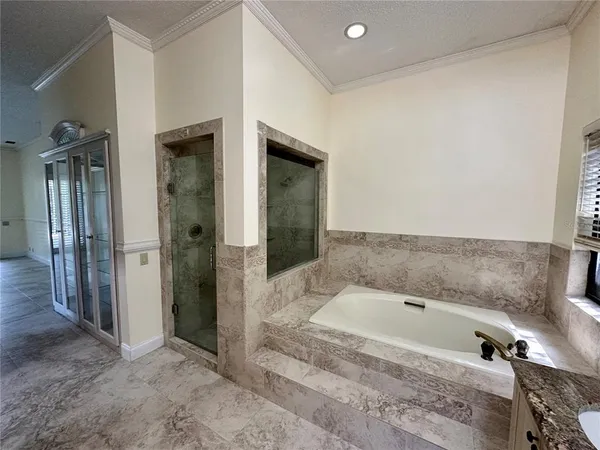 a bathroom with a tub and shower