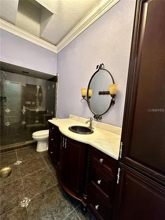a bathroom with a toilet sink and mirror