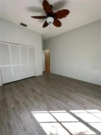 a view of an empty room with wooden floor