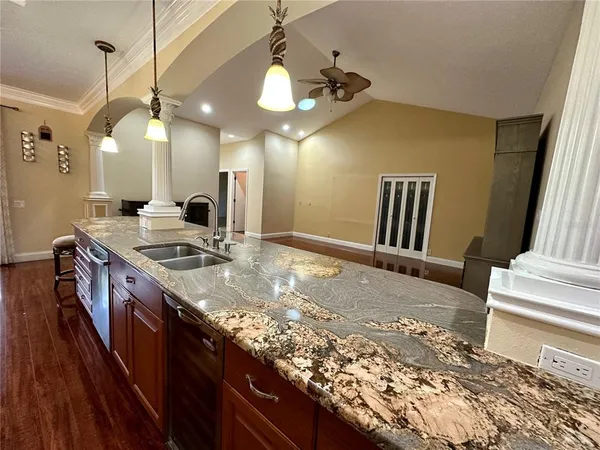 a kitchen with a stove a sink and a refrigerator