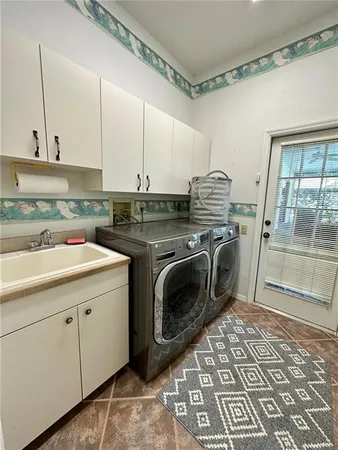 a kitchen with a stove sink and cabinets