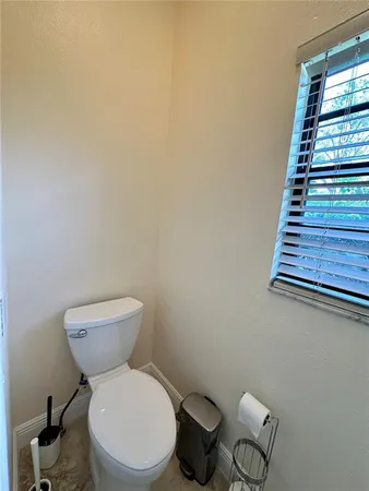 a white toilet sitting next to a window