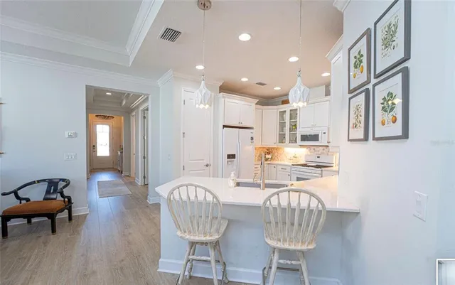 a kitchen with granite countertop kitchen island stainless steel appliances a table and chairs