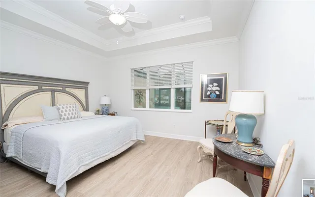 a bedroom with a bed wooden floor and a window