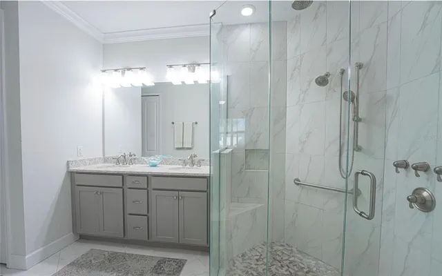 a bathroom with a double vanity sink shower and mirror