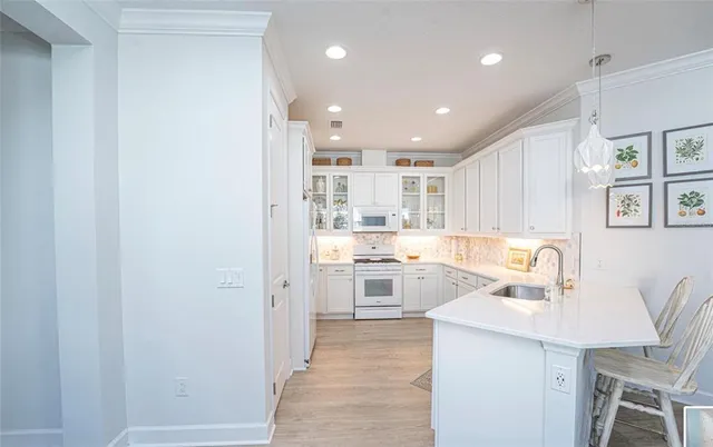 a kitchen with a sink a stove a refrigerator and a refrigerator