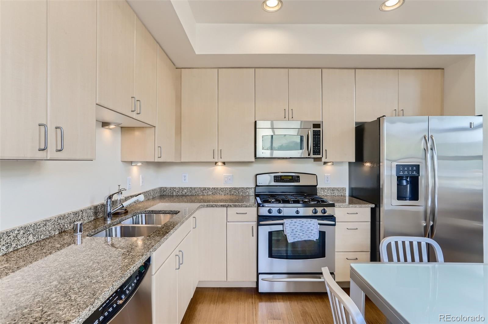 4580 Broadway, Unit 223 Boulder, CO 80304 - Photo 11 of 28 a kitchen with a sink white cabinets and stainless steel appliances