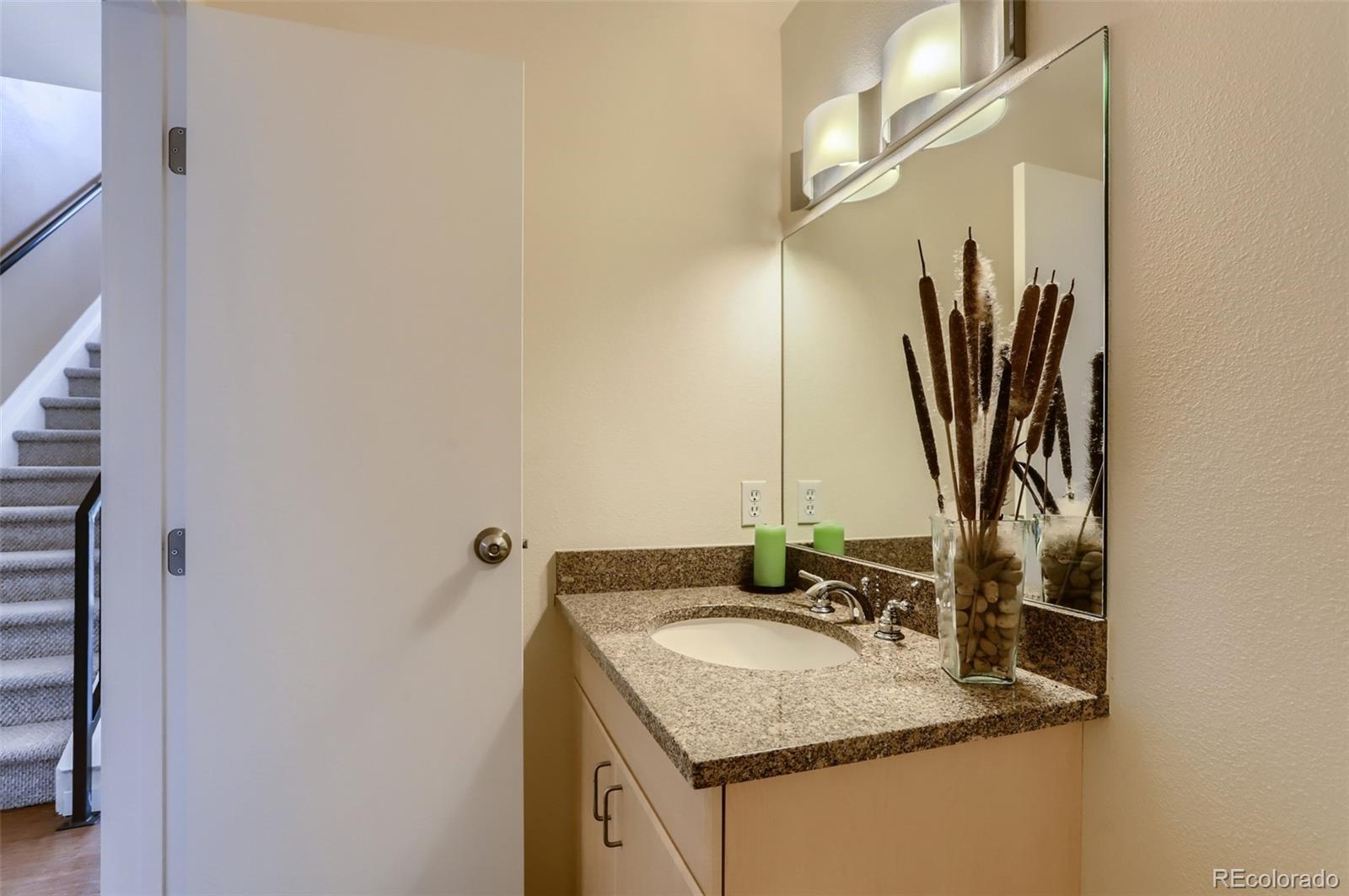 4580 Broadway, Unit 223 Boulder, CO 80304 - Photo 13 of 28 a bathroom with a granite countertop sink and a mirror
