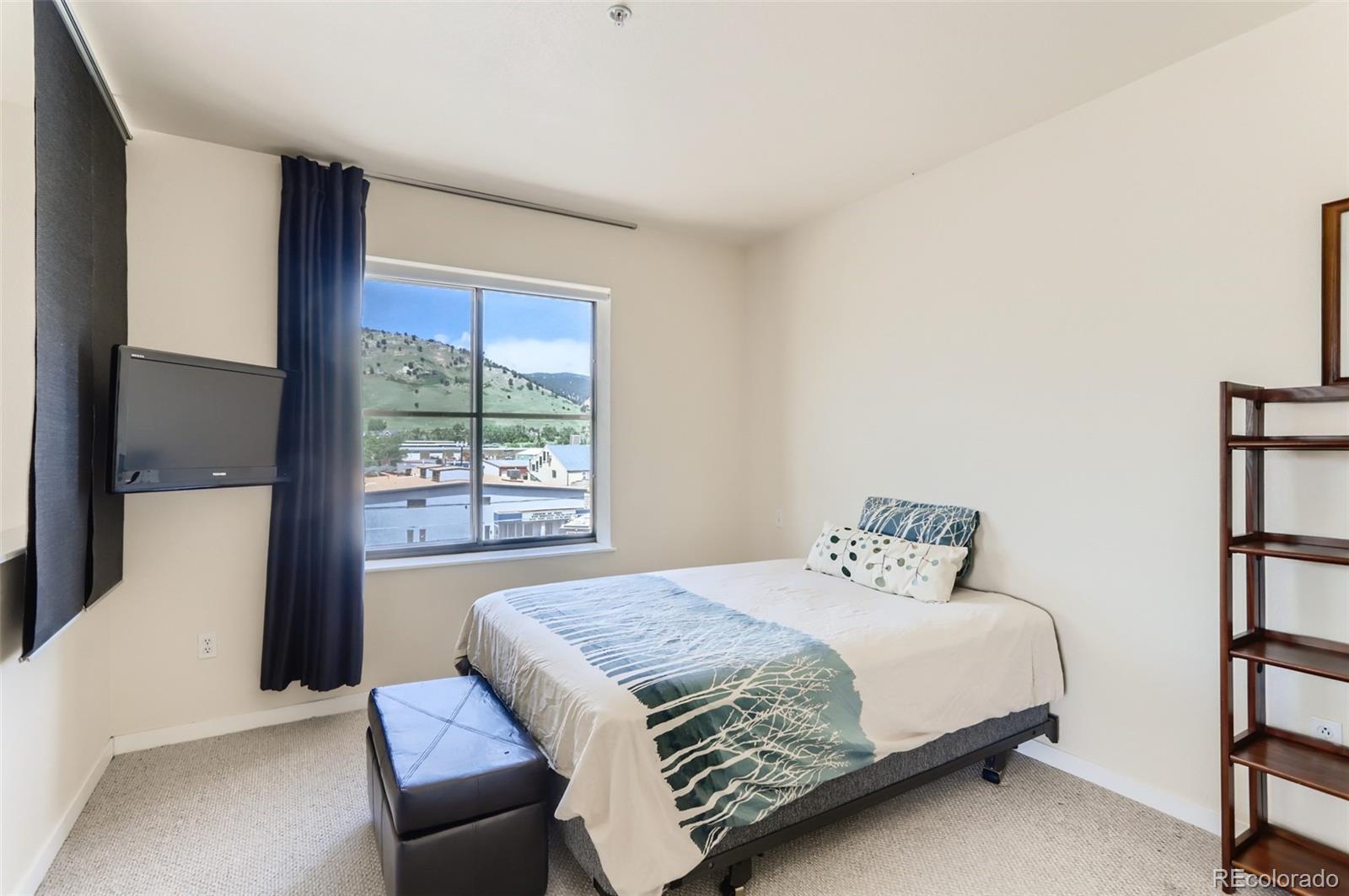 4580 Broadway, Unit 223 Boulder, CO 80304 - Photo 18 of 28 a bedroom with a bed and a window