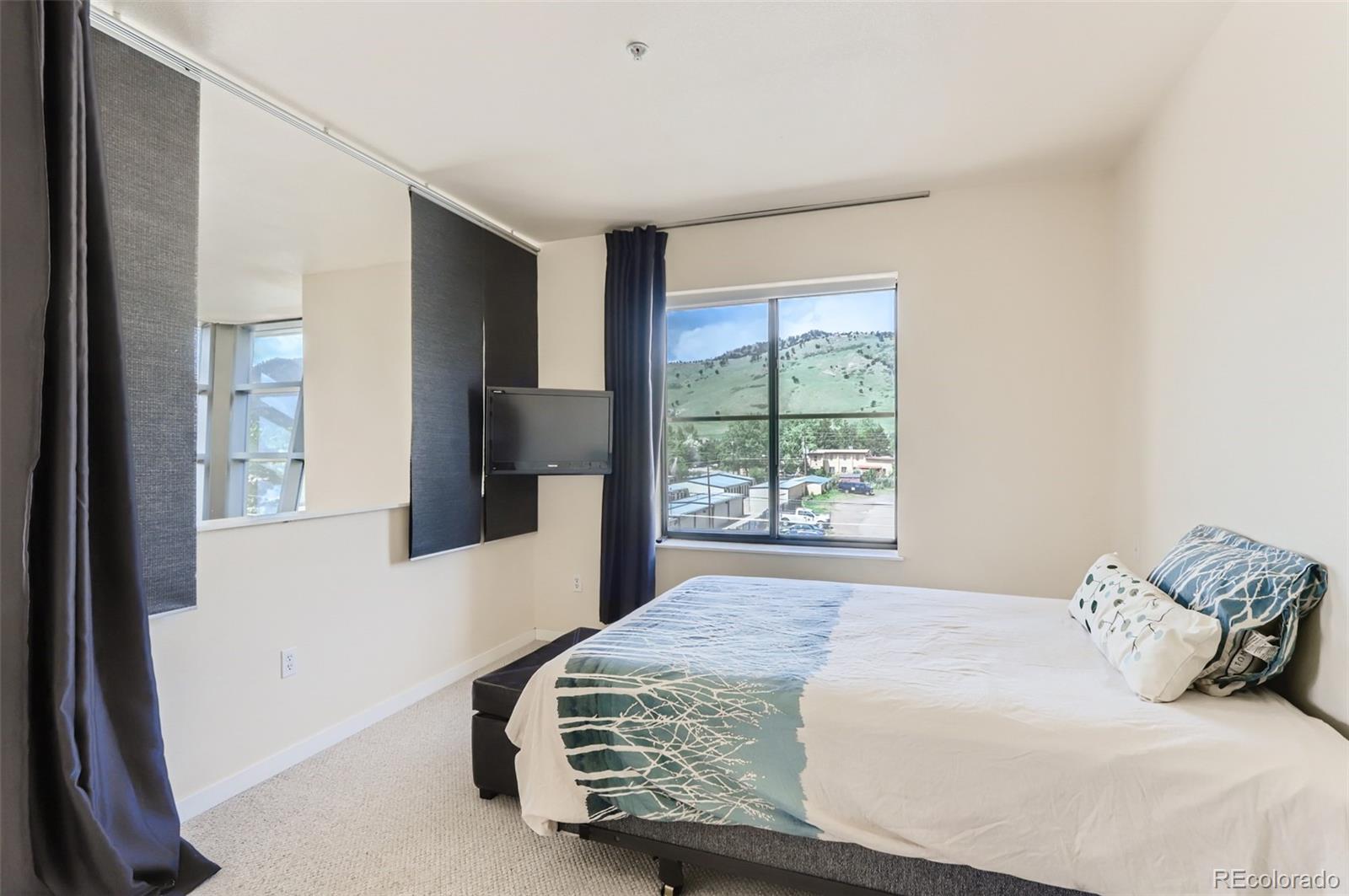 4580 Broadway, Unit 223 Boulder, CO 80304 - Photo 19 of 28 a bedroom with a bed and a window