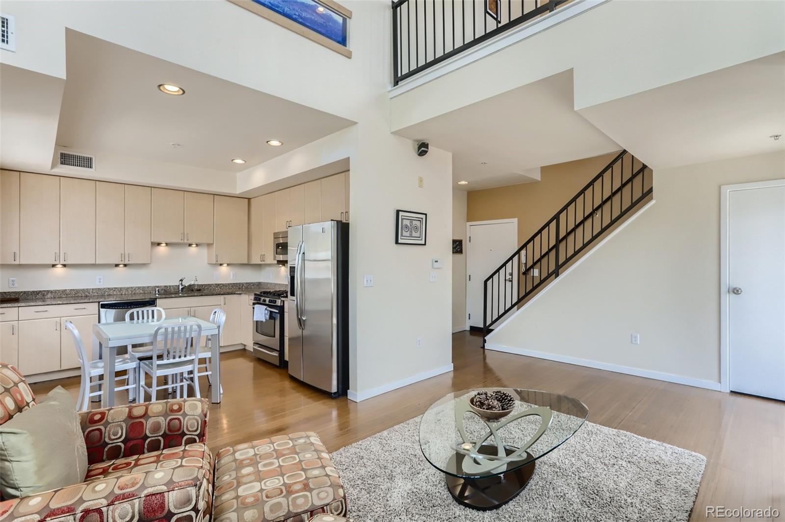 4580 Broadway, Unit 223 Boulder, CO 80304 - Photo 6 of 28 a kitchen with stainless steel appliances kitchen island granite countertop a sink refrigerator and cabinets
