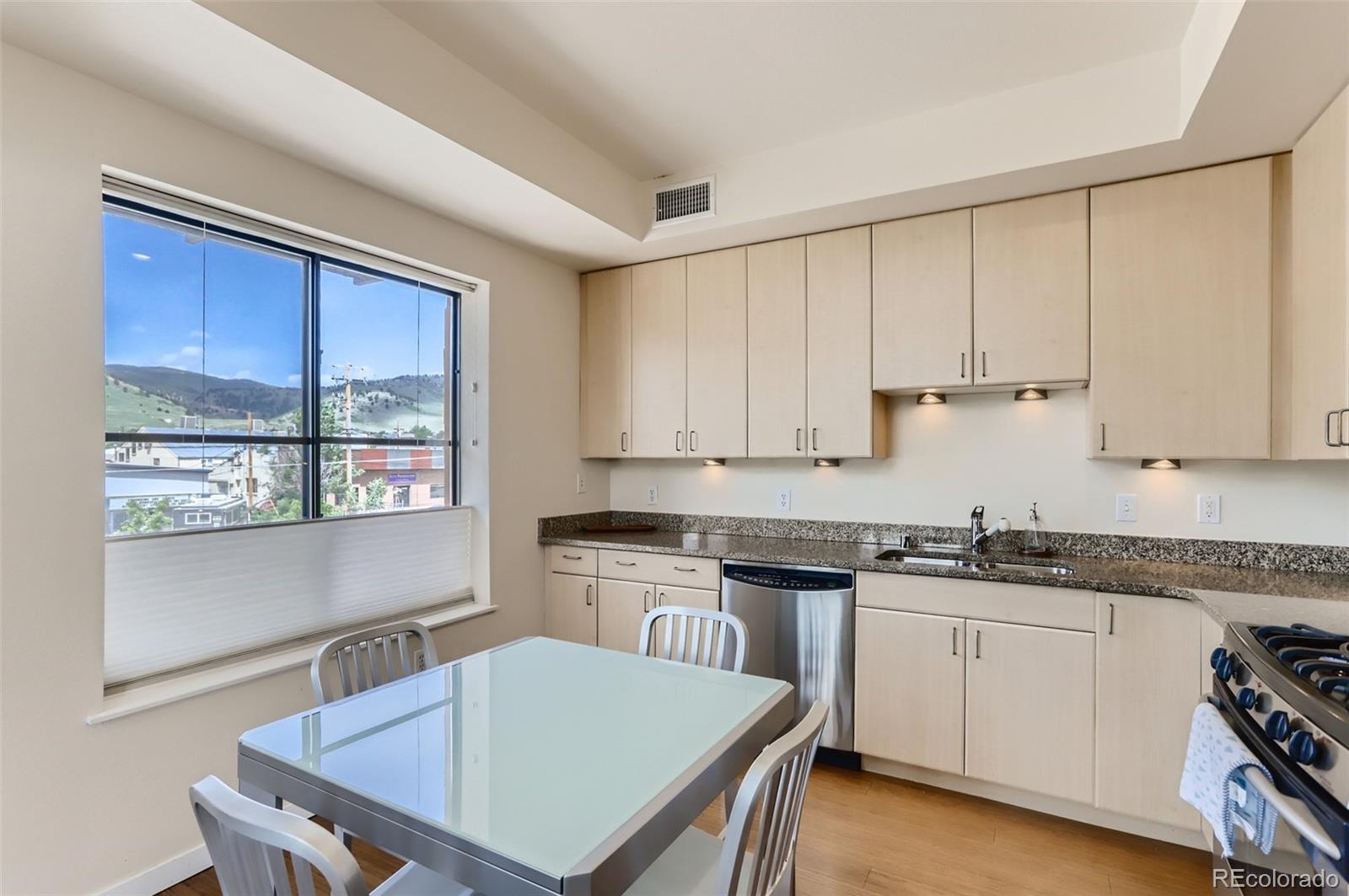 4580 Broadway, Unit 223 Boulder, CO 80304 - Photo 9 of 28 a kitchen with a stove a sink a window and cabinets