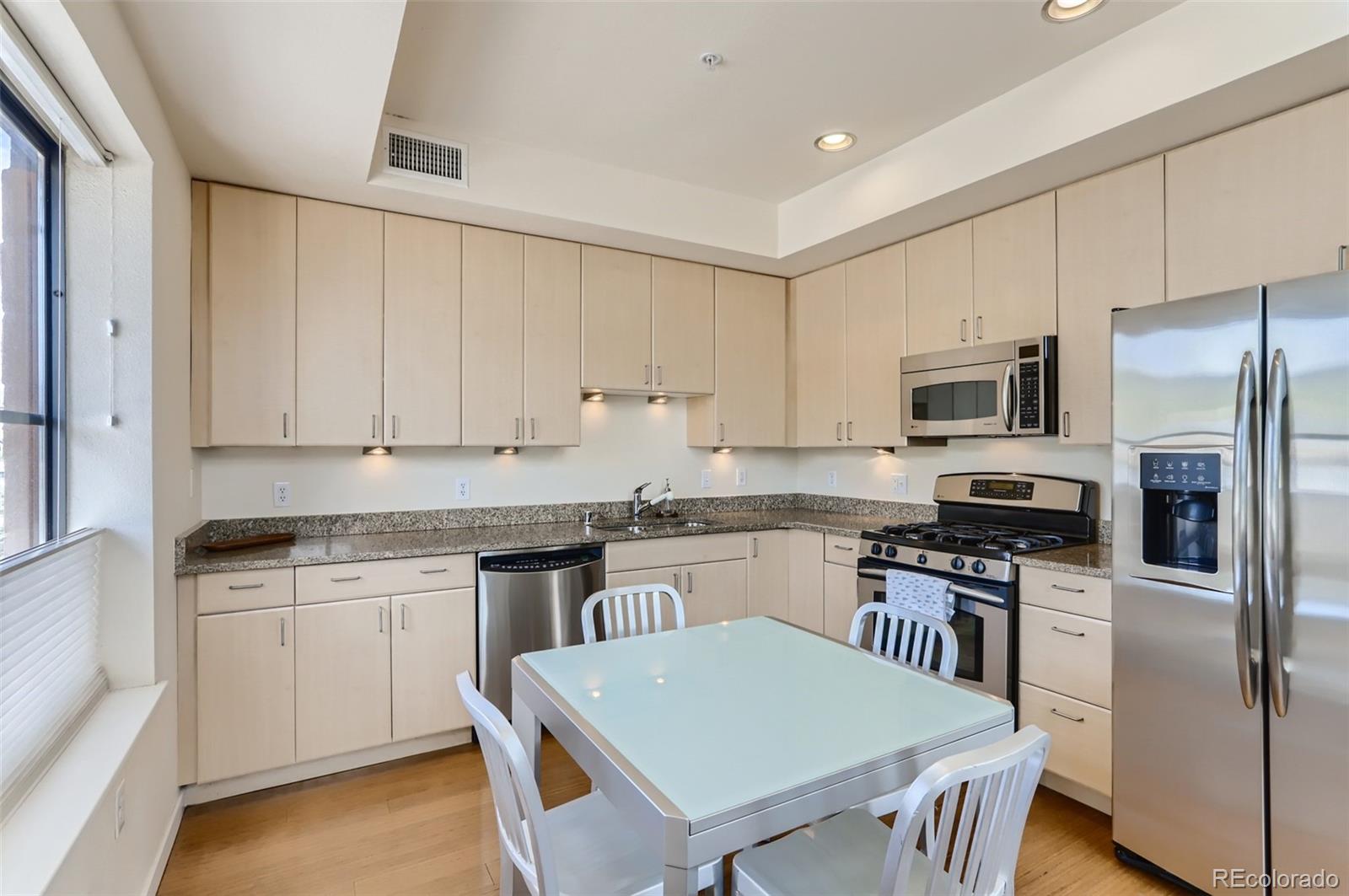4580 Broadway, Unit 223 Boulder, CO 80304 - Photo 10 of 28 a kitchen with stainless steel appliances granite countertop a stove top oven a refrigerator a sink and dishwasher