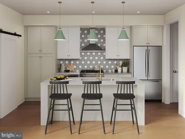 a kitchen with stainless steel appliances kitchen island granite countertop a refrigerator and a stove top oven